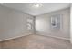 Cozy carpeted bedroom with two windows offering ample natural light for a warm and inviting ambiance at 2304 Mystic Maze Ln, Clermont, FL 34715