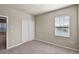 Bedroom featuring neutral carpet, a closet, and a window offering natural light at 2304 Mystic Maze Ln, Clermont, FL 34715