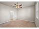 Neutral bedroom with carpet, ceiling fan, and doorway leading to another room at 2304 Mystic Maze Ln, Clermont, FL 34715
