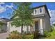 Attractive two-story home with a well-maintained lawn, brick driveway, and a convenient two-car garage at 2304 Mystic Maze Ln, Clermont, FL 34715