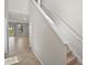 Hallway leading to an open-concept living space and staircase with neutral color palette at 2304 Mystic Maze Ln, Clermont, FL 34715