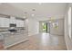 Open-concept living space featuring a kitchen with a central island, flowing into a spacious living area at 2304 Mystic Maze Ln, Clermont, FL 34715