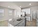 Stylish kitchen island with granite countertop, stainless steel sink, and seating, perfect for entertaining guests at 2304 Mystic Maze Ln, Clermont, FL 34715