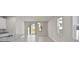 Bright living room with tile floors, sliding glass doors, and a view of the backyard at 2304 Mystic Maze Ln, Clermont, FL 34715
