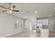 Spacious living room with white cabinets, stainless steel appliances, recessed lighting, and tile floors at 2304 Mystic Maze Ln, Clermont, FL 34715