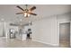 Open living area with stainless steel appliances, tile flooring, and a modern ceiling fan at 2304 Mystic Maze Ln, Clermont, FL 34715