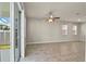 Open concept living space features tile floors, ceiling fan, and sliding doors to outdoor area at 2304 Mystic Maze Ln, Clermont, FL 34715