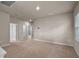 Spacious loft area with neutral carpets, multiple doors, and a ceiling fan at 2304 Mystic Maze Ln, Clermont, FL 34715