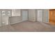 Upstairs loft area with neutral carpeting, closet, and natural light from windows at 2304 Mystic Maze Ln, Clermont, FL 34715