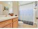 Bathroom featuring a vanity with a sink, a seashell decoration, and a shower with a blue patterned curtain at 27401 Pine Straw Rd, Leesburg, FL 34748