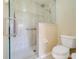 Modern bathroom featuring a glass shower with dual showerheads and a tiled shower base at 27401 Pine Straw Rd, Leesburg, FL 34748