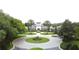 Beautiful community clubhouse entrance framed by palm trees and manicured lawns, welcoming residents and guests at 27401 Pine Straw Rd, Leesburg, FL 34748