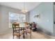 Cozy dining area featuring a round table, four chairs, and a window for natural light at 27401 Pine Straw Rd, Leesburg, FL 34748