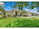 Well-maintained single-story home with a manicured lawn and beautiful landscaping at 27401 Pine Straw Rd, Leesburg, FL 34748