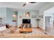 Cozy living room with plush furniture, hardwood flooring, and a ceiling fan for added comfort at 27401 Pine Straw Rd, Leesburg, FL 34748