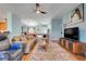 Bright, spacious living area featuring hardwood floors and comfortable seating, leading to dining area at 27401 Pine Straw Rd, Leesburg, FL 34748