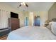Spacious main bedroom offering wood floors, ceiling fan, closet space and ample natural light at 27401 Pine Straw Rd, Leesburg, FL 34748