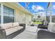 Screened in patio featuring comfortable seating arrangements, a ceiling fan and a view of the yard at 27401 Pine Straw Rd, Leesburg, FL 34748
