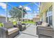 Relaxing screened patio with wicker furniture, perfect for enjoying the outdoors in comfort and style at 27401 Pine Straw Rd, Leesburg, FL 34748