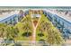 Aerial view of condominiums with a community pool, palm trees, and manicured lawns that lead to the ocean at 2750 Ocean Shore Blvd # 350, Ormond Beach, FL 32176