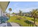Balcony view showcasing beautiful landscaping, palm trees, and ocean views beyond at 2750 Ocean Shore Blvd # 350, Ormond Beach, FL 32176