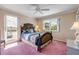 Cozy bedroom featuring large windows for ample natural light and ceiling fan at 2750 Ocean Shore Blvd # 350, Ormond Beach, FL 32176
