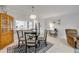Cozy dining area with a glass-top table, view into the kitchen and backyard at 2750 Ocean Shore Blvd # 350, Ormond Beach, FL 32176