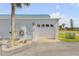 Charming condo with well-manicured landscape, white garage door and entryway door, and a bright blue roof at 2750 Ocean Shore Blvd # 350, Ormond Beach, FL 32176