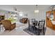 Comfortable living room and dining area with tile flooring, ceiling fan, and access to outdoor patio at 2750 Ocean Shore Blvd # 350, Ormond Beach, FL 32176
