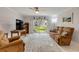 Spacious living room featuring a plush sofa, tile flooring, ceiling fan, and sliding door to patio at 2750 Ocean Shore Blvd # 350, Ormond Beach, FL 32176