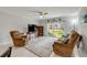 Bright living room with comfortable seating, ceiling fan, and sliding glass door to a grassy area at 2750 Ocean Shore Blvd # 350, Ormond Beach, FL 32176