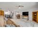 Open-concept living room and dining area, featuring tile flooring, ceiling fan, and ample natural light at 2750 Ocean Shore Blvd # 350, Ormond Beach, FL 32176