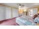Comfortable main bedroom with ceiling fan, closet, and a connecting bathroom at 2750 Ocean Shore Blvd # 350, Ormond Beach, FL 32176