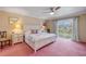 Spacious main bedroom featuring a ceiling fan, balcony access, and decorative headboard at 2750 Ocean Shore Blvd # 350, Ormond Beach, FL 32176
