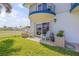 The private covered patio features outdoor seating on lush green grass, perfect for relaxation at 2750 Ocean Shore Blvd # 350, Ormond Beach, FL 32176