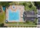 Aerial view of the community pool and clubhouse including a large pool, chairs, tables, and parking at 2842 Balforn Tower, Winter Garden, FL 34787