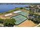 Aerial view of tennis and athletic courts along with a stunning lake view at 2842 Balforn Tower, Winter Garden, FL 34787