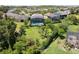Aerial view showcasing the backyard oasis, screened in pool, tropical landscaping, and mature trees at 2842 Balforn Tower, Winter Garden, FL 34787