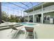 Backyard featuring a pool and spa with patio chairs for relaxing near a home with a balcony at 2842 Balforn Tower, Winter Garden, FL 34787
