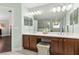 Bright bathroom with a double vanity, well-lit mirrors, and ample counter space at 2842 Balforn Tower, Winter Garden, FL 34787