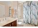 Bathroom with a shower and a peacock-themed shower curtain that complements the vanity and fixtures at 2842 Balforn Tower, Winter Garden, FL 34787