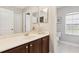Bright bathroom features a large mirror, vanity with sink, and a neutral color palette at 2842 Balforn Tower, Winter Garden, FL 34787