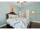 Bedroom featuring peacock-themed bedding, connecting to the bathroom, and providing a private sanctuary at 2842 Balforn Tower, Winter Garden, FL 34787