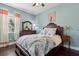 Charming bedroom with a peacock-themed quilt and light blue walls, creating a cozy and inviting atmosphere at 2842 Balforn Tower, Winter Garden, FL 34787