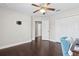 This bedroom has a closet, ceiling fan, wood floors, and a hall entrance at 2842 Balforn Tower, Winter Garden, FL 34787