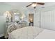 This bedroom has a closet, wood floors, a ceiling fan, and bright natural light at 2842 Balforn Tower, Winter Garden, FL 34787