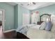 Light-filled bedroom with dark hardwood floors, closet, and neutral walls, creating a serene retreat at 2842 Balforn Tower, Winter Garden, FL 34787