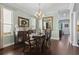 Formal dining area with a chandelier, hardwood floors, and a view into the kitchen at 2842 Balforn Tower, Winter Garden, FL 34787