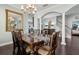 Open-concept dining area with hardwood floors, a large mirror, and access to multiple rooms at 2842 Balforn Tower, Winter Garden, FL 34787