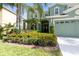 Inviting two-story home with lush landscaping featuring vibrant flowers, adding to the curb appeal at 2842 Balforn Tower, Winter Garden, FL 34787